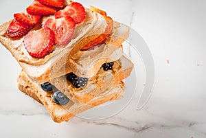 Sandwiches with peanut butter, berry and fruit