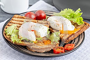 Sandwiches with poached egg on rye bread.