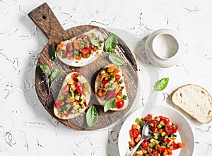 Sandwiches with quick ratatouille on rustic cutting board on a light background. Delicious healthy vegetarian food