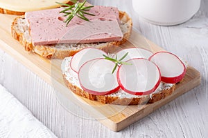 Sandwiches with radishes, cottage cheese and sausage