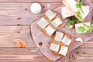 Sandwiches from rye bread and salted bacon on a cutting board