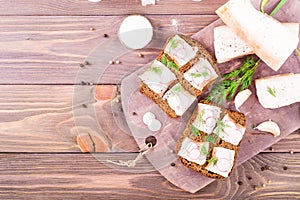 Sandwiches from rye bread, salted bacon, radish and dill