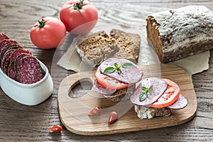 Sandwiches with salami and tomatoes photo