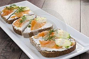 Sandwiches with salmon, ricotta, dill and cucumber.