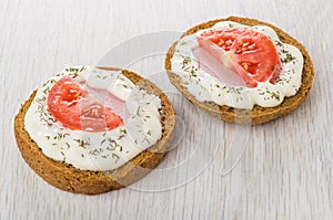 Sandwiches with sausage, tomatoes, mayonnaise, dill on table
