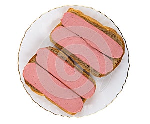 Sandwiches with sausages in glass plate isolated on white. Top view