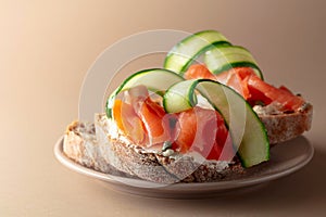 Sandwiches with smoked trout, cream cheese, fresh cucumber and capers