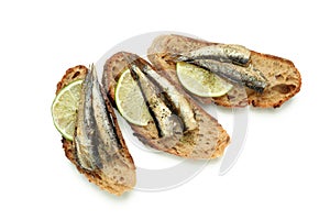 Sandwiches with sprats isolated on white background