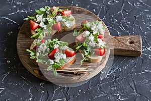 Sandwiches with strawberries, arugula and blue cheese. Delicious snack, breakfast or a snack with wine.