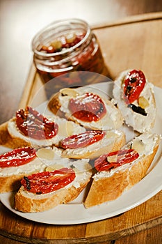 sandwiches with sun-dried tomatoes and cheese on a plate on the table
