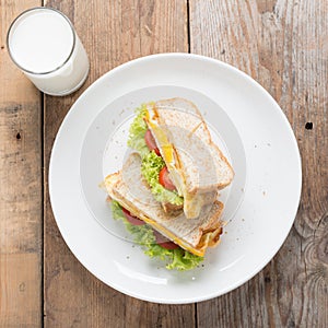 Sandwichs fried egg with cheese and milk.