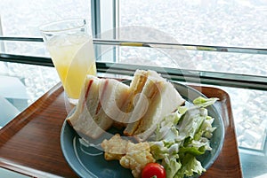 Sandwishes, salad and pineapple juice breakfast