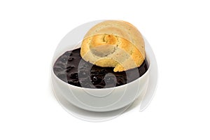 Sandy bagel in a Cup with jam on a white background
