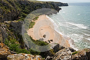 Sandy bay surrounded by rocks. summer empty beach