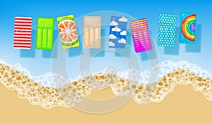 Sandy beach background with color inflatable mattresses