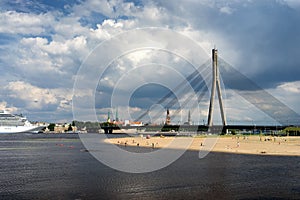 The sandy beach on the background of the panorama of Riga
