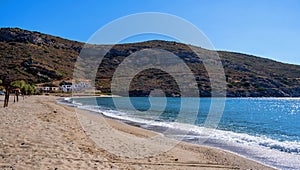 Sandy beach, blue clear sky, calm sea water background, Greece. Kea island