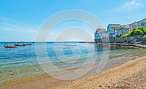 The sandy beach and blue sea near Peveril Point Swanage England on a bright May day