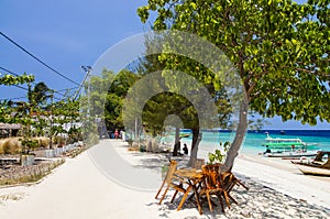 Sandy beach with blue water on the tropical island of Gili Meno. The main promenade of the island