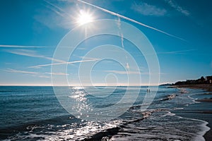sandy beach of the Bolearic sea with beautiful waves against the background of a sunny sky