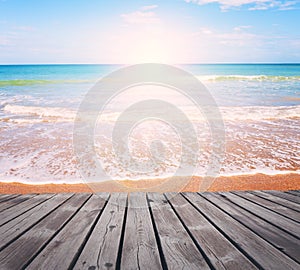 Sandy beach on bright sunny morning with wooden walkway.