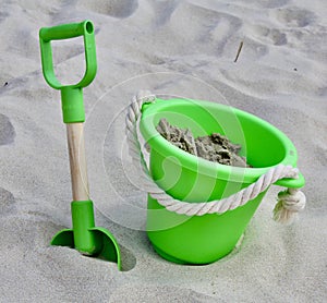 Sandy beach with bucket and spade