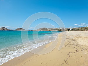 Sandy beach calm sea at Mykonos island, Cyclades Greece. Space, card, advertisement template photo