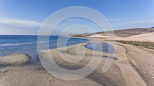 Sandy beach with dunes, water pools in Canary Islands