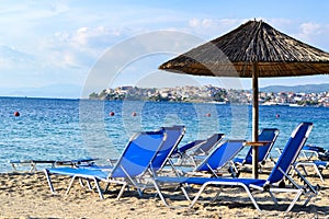 The sandy beach with with empty sun loungers anticipation of the tourist season, Greece