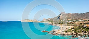 The sandy beach at the foot of the rocky cliffs in the arid countryside , in Europe, Greece, Crete, towards Kissamos, towards