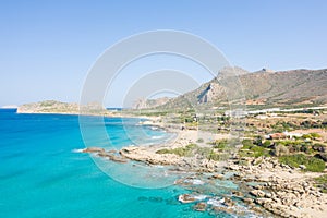 The sandy beach at the foot of the rocky cliffs in the arid countryside , in Europe, Greece, Crete, towards Kissamos, towards