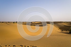 The sandy beach at the foot of the rocky cliffs in the arid countryside , in Europe, Greece, Crete, towards Kissamos, towards