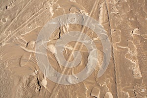 Sandy beach, footprints on the wet sand