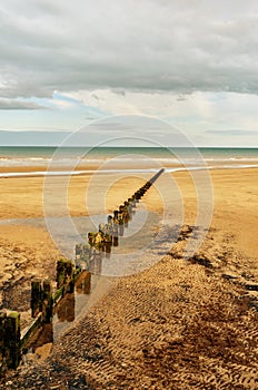 Sandy beach and groyne photo