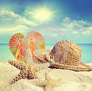 Sandy beach, hat and starfish in summer