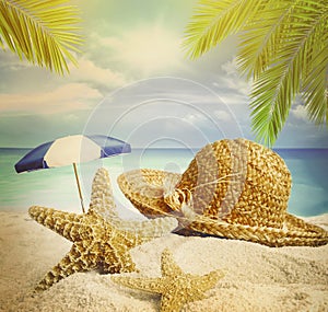 Sandy beach, hat and starfish in summer sand