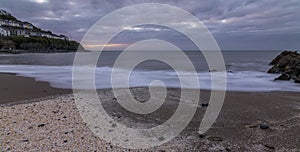 A sandy beach and headland in the harbor town of New Quay on Cardigan coast, Wales