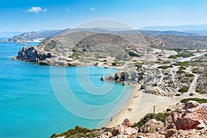 Sandy beach and lagoon with clear blue water at Crete island near Sitia town, Greece.