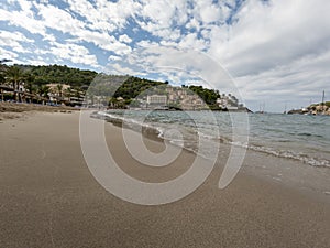 Sandy beach landscape of Meditteranean sea coast and mountain background in Port de Soller, Palma de Mallorca, Spain, Europe