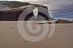 sandy beach with large rocks . Praia de Augas Santas photo