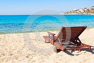 The sandy beach near the blue sea with sun beds. Mykonos
