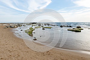 Sandy beach near Scala dei Turchi Stair of the Turks in Argigento, Sicily during the beautiful sunset with boulders and green