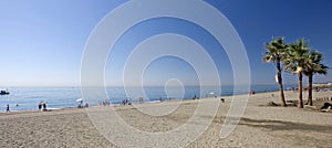 Sandy beach with palm trees at Estepona in Southern Spain