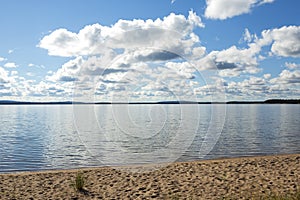 Sandy beach on a partly cloudy day.