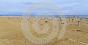 Sandy beach with permanent umbrella stands