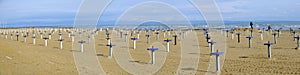 Sandy beach with permanent umbrella stands