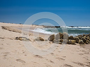 Sandy beach in Portugal, Povoa de Varzim, looking over sandstone rocks