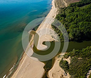 Sandy beach and a river that flows into the sea