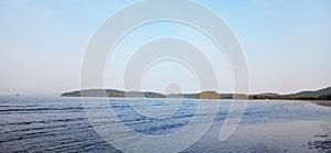 Sandy beach and sea on a calm day, Mountains coast island sky sea clouds boat photo