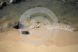 Sandy beach with stone peddle